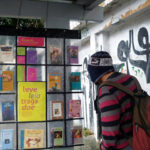 A passenger peruses a book stop in Brazil